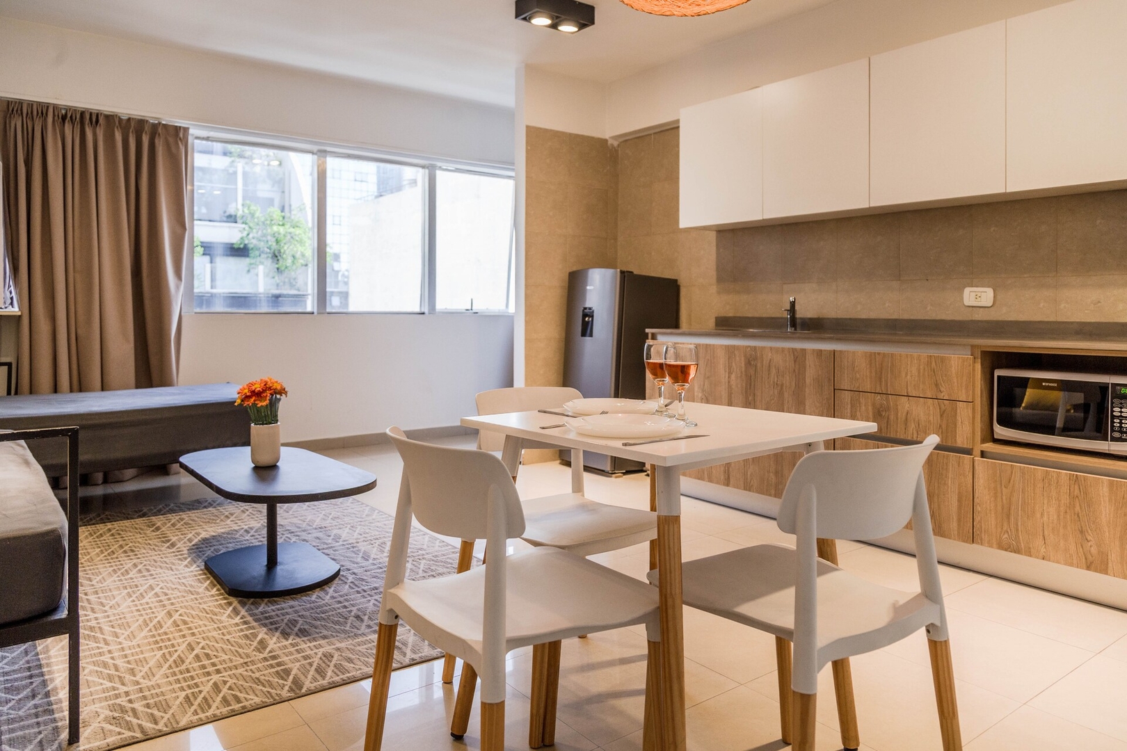 Dining table and chairs beside a kitchen in a Buenos Aires apartment