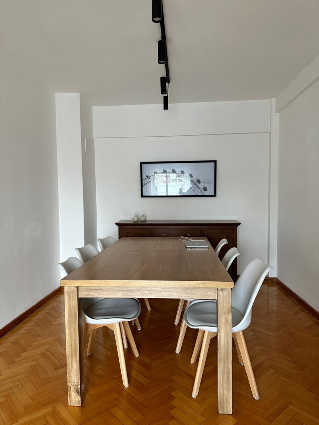 Dining table and chairs with a laptop on the table