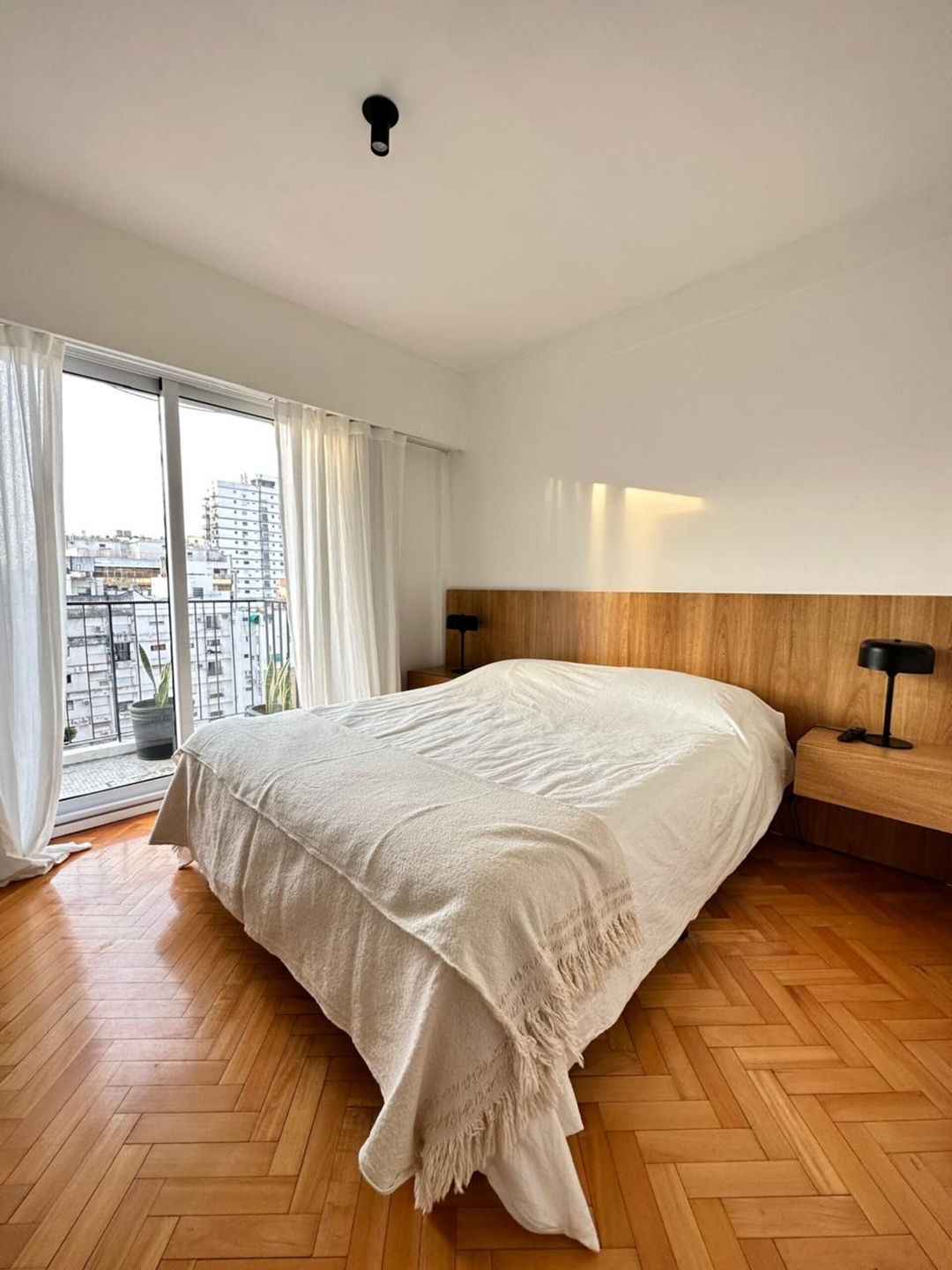 Bedroom with a double bed and balcony door