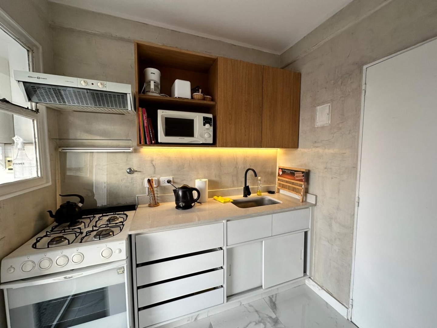 Kitchen with an oven, microwave and small appliances