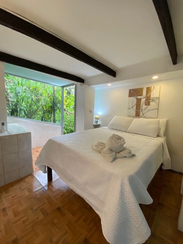 Tropical budget room with balcony and kitchen