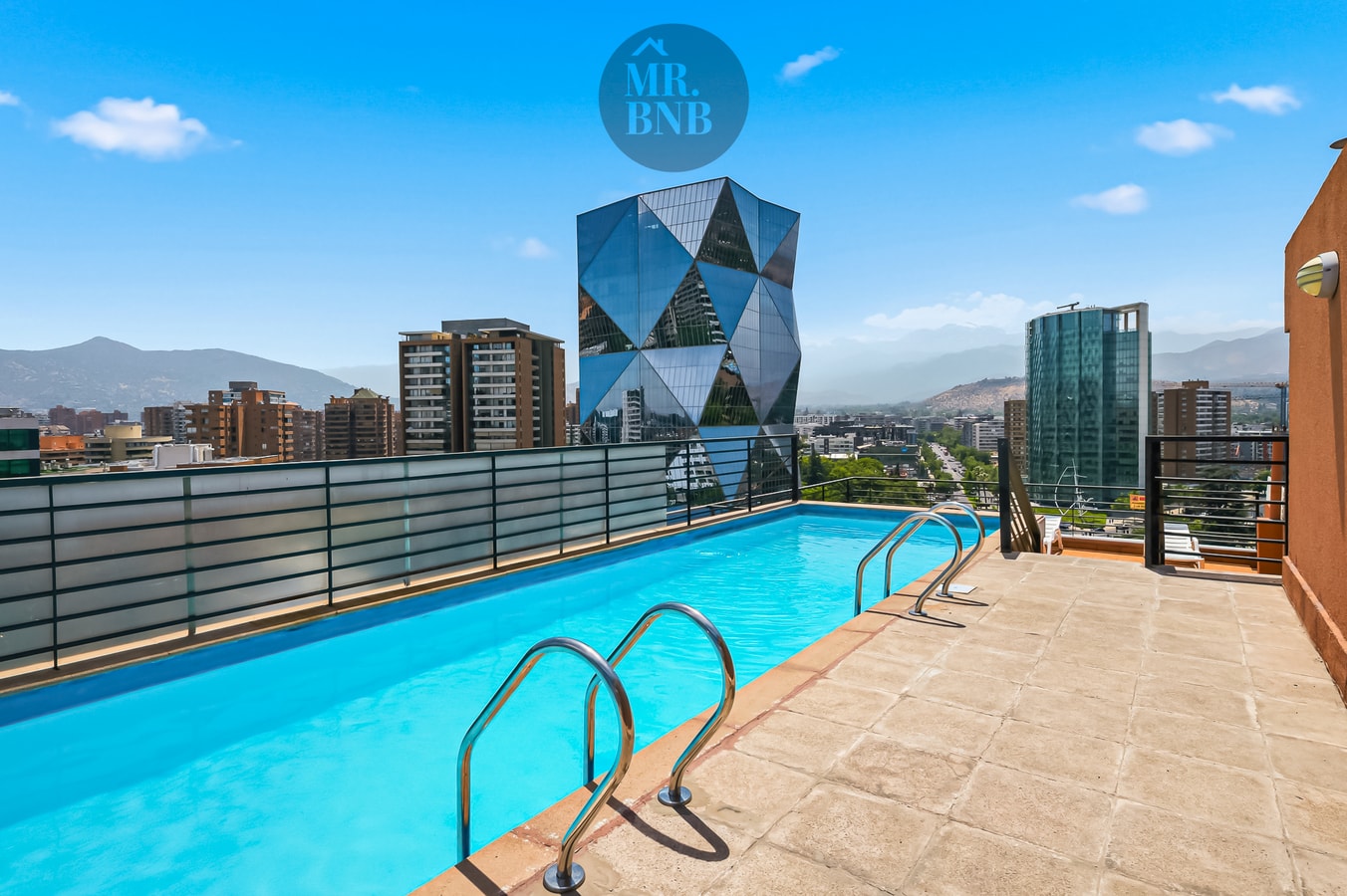 Piscina en azotea del edificio con vista panorámica a la ciudad.