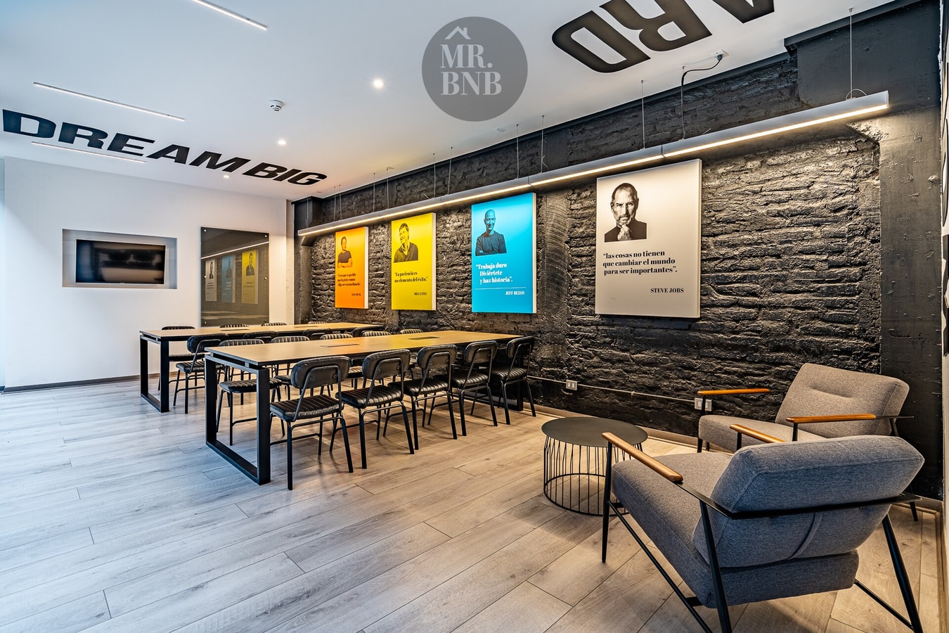 Sala de cowork del edificio con mesa larga compartida, sillas y ambientación de trabajo.