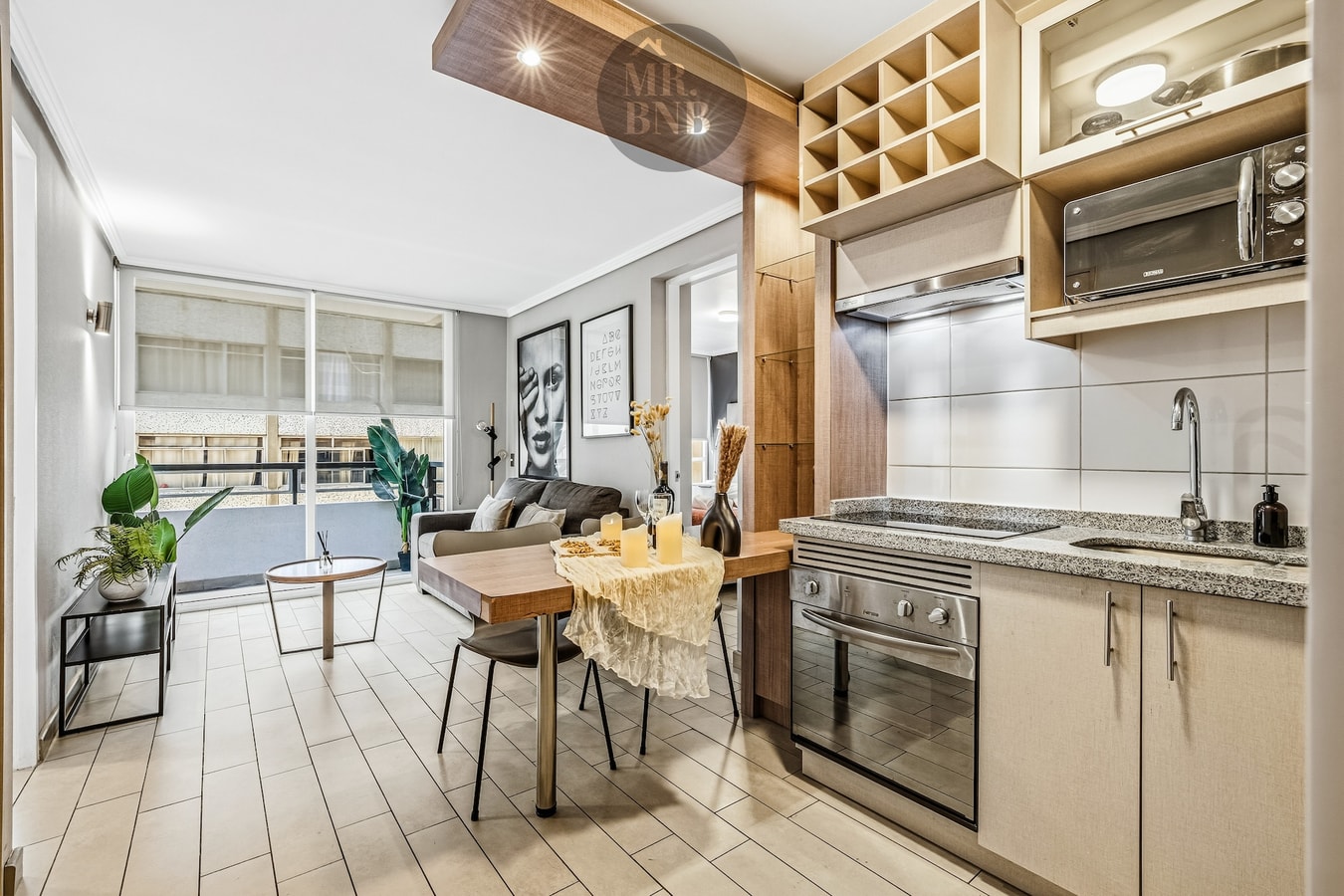 Living comedor con sofá, mesa y cocina integrada al fondo